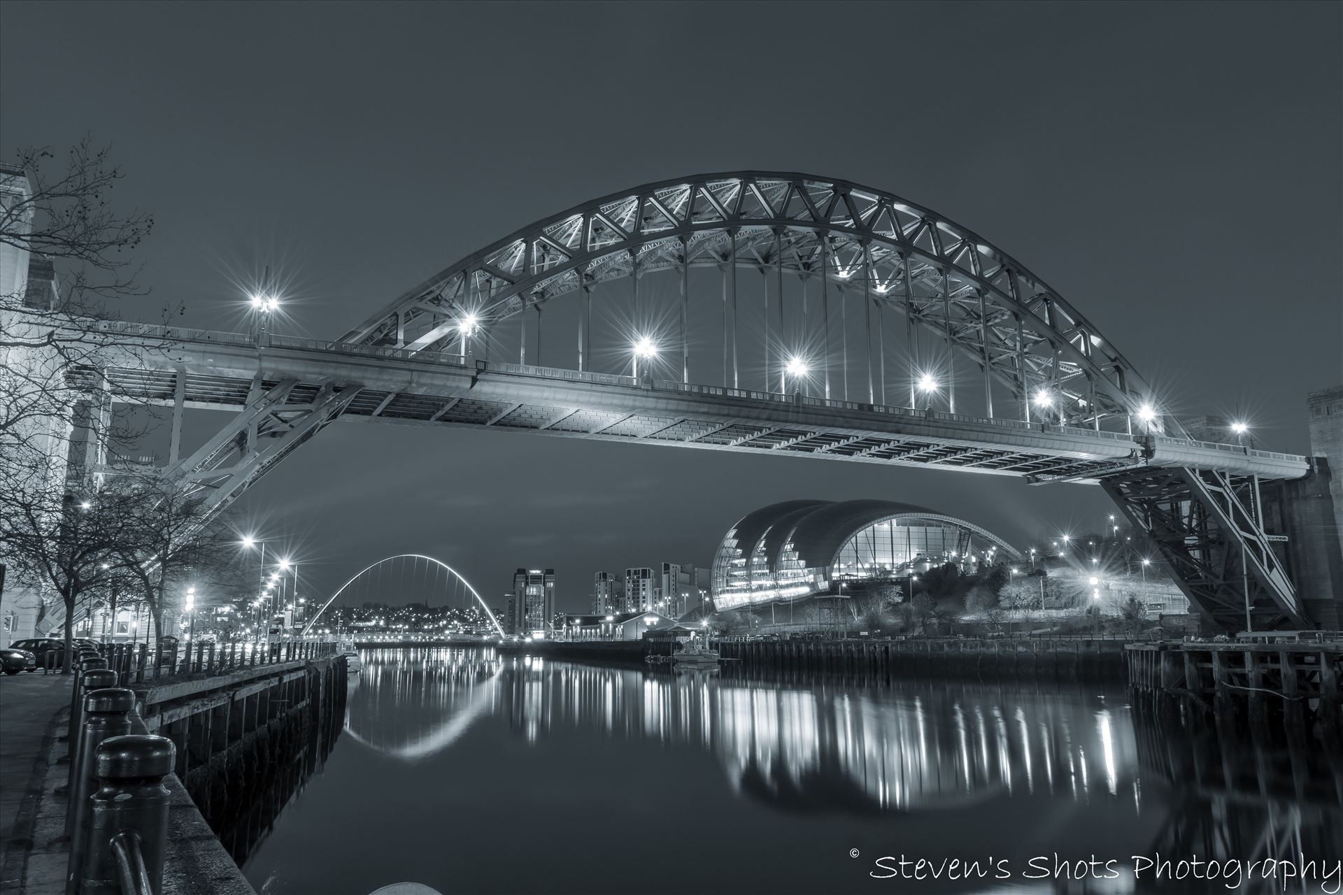 Tyne Bridge in black and white - The Tyne Bridge in black and white, shot in front of the swing bridge looking down towards the Millennium Bridge on Newcastle quayside.  by Steven's Shots Photography