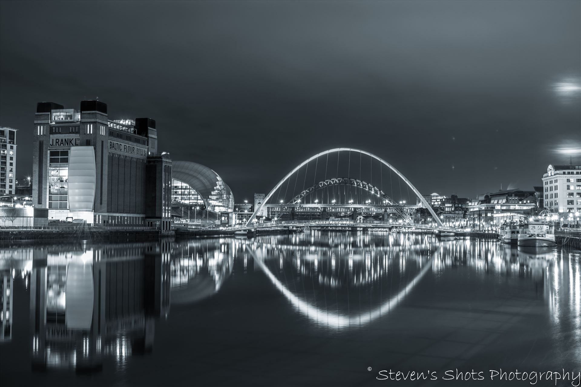 Millennium Bridge and Tyne Bridge - A black and white picture of the Millennium Bridge and Tyne Bridge on Newcastle quayside, the Baltic is visible also. by Steven's Shots Photography