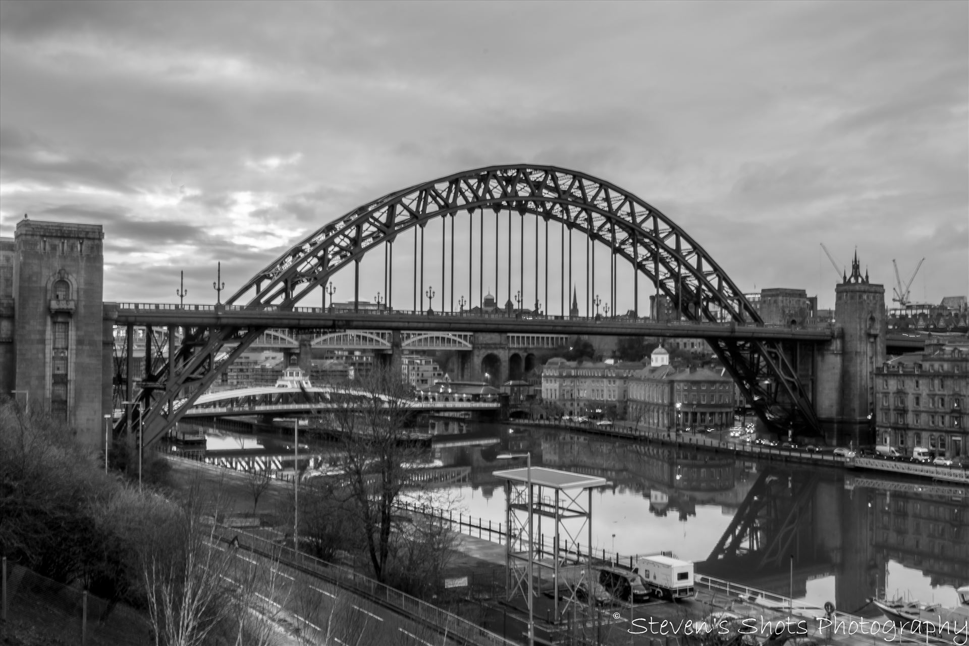 Tyne Bridge in black and white - A shot of the Tyne Bridge in black and white from outside the Sage looking towards the Swing Bridge and High level bridge. by Steven's Shots Photography