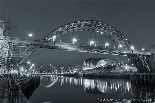 The Tyne Bridge in black and white, shot in front of the swing bridge looking down towards the Millennium Bridge on Newcastle quayside. 